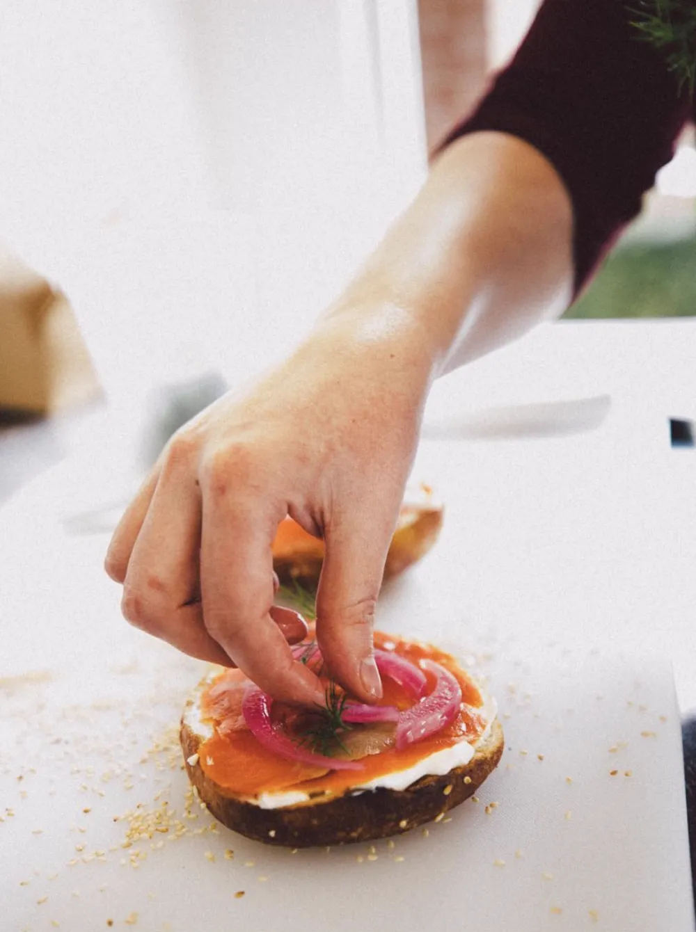 A smoked salmon bagel being made at Good Kid Coffee