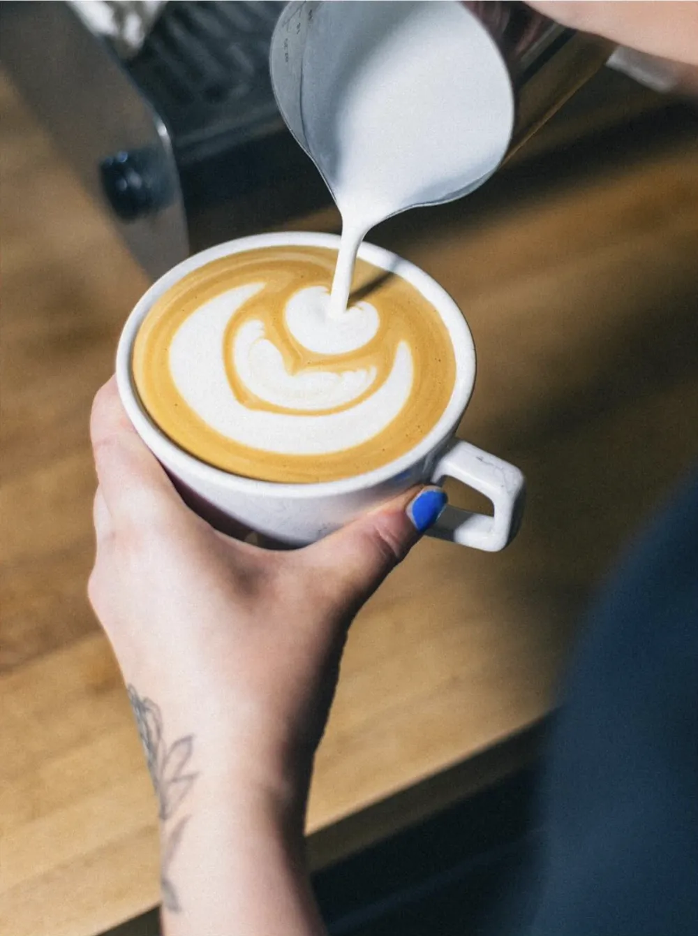 A latte being poured at Good Kid Coffee
